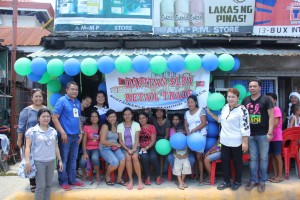 Partner-beneficiaries of Pantawid Pamilya and Sustainable Livelihood Program (SLP) pose for a souvenir photo during the opening of their general merchandise store.