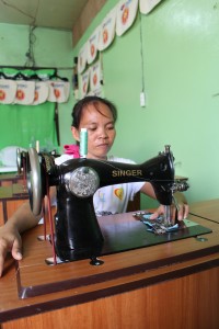 Jennifer Quiño shows off their group’s newly purchased sewing machine.