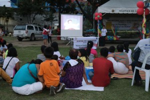 Participating families and representatives from different agencies enjoy watching a classic family-oriented animated film. 