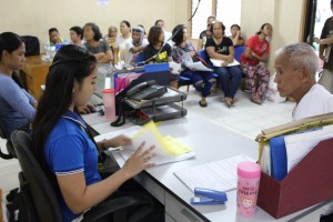 DSWD-7 personnel assess the submitted documents as part of the requirements in availing E-AICS.