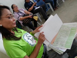 Development Management Officer Hazel Torrefiel of NCIP checks the names printed in the birth certificates of Sama-Bajaus prior to its distribution.